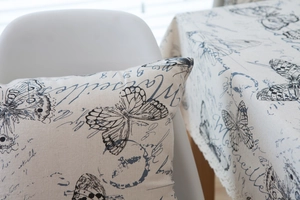 Detail of vintage linen tablecloth featuring blue butterfly and artistic lettering print