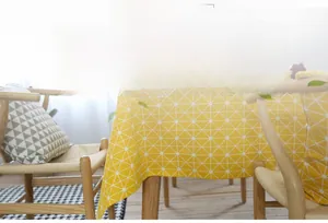 Detail of yellow cotton linen tablecloth with white geometric pattern for rectangle tables