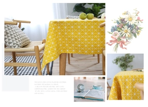 Detail of yellow geometric linen cotton tablecloth with white triangle grid pattern