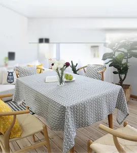 Close-up of gray and white geometric cotton linen tablecloth on a wooden table