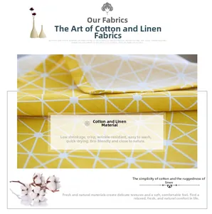 Close-up of yellow linen tablecloth with white geometric patterns and natural fiber texture