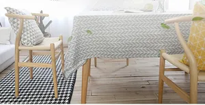Detail of gray and white herringbone geometric tablecloth with soft cotton linen texture