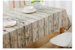 Detail of Nordic style rectangular tablecloth with vintage wood grain texture and floral decor
