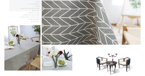 Detail of grey cotton linen tablecloth with white chevron pattern and soft fabric texture