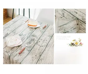 Detail of vintage light wood grain tablecloth with durable and washable fabric texture