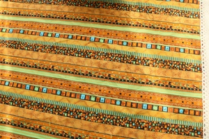 Close-up of bohemian linen tablecloth with geometric patterns and white lace edges