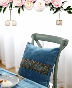 Detailed view of peacock blue velvet pillowcase featuring ornate vintage embroidery