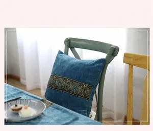 Close-up of luxury dark blue velvet pillow with elegant jacquard embroidery detail