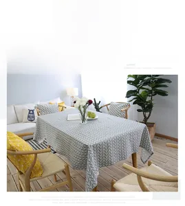 Close-up of rectangle linen tablecloth featuring grey and white geometric arrow patterns