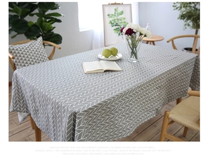 Detailed view of grey herringbone cotton linen tablecloth on a modern dining table