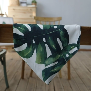Nordic monstera leaf table runner with green foliage pattern on textured linen canvas fabric