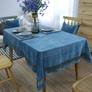 Detail van blauw fluwelen tafelkleed met luxe gouden Griekse borduurpatronen