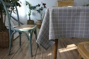 Close-up of grey and white grid linen tablecloth with high-quality stitching details