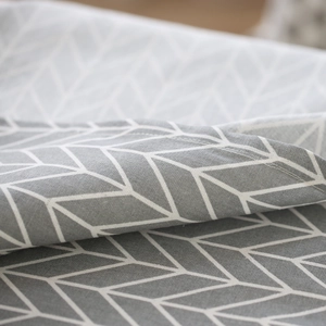 Minimalist geometric linen tablecloth featuring grey arrow patterns and premium edge stitching