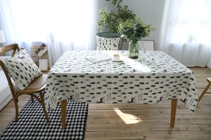 Detail of linen tablecloth and cushion set with forest deer pattern and English text