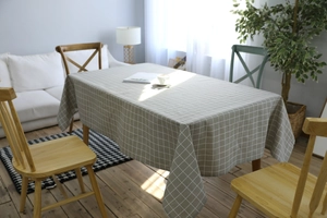 Detail shot of grey and beige plaid linen tablecloth in a cozy home dining room