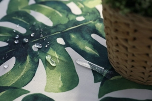 Waterproof detail of monstera leaf table runner showing water droplets on fabric surface
