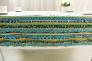 Detailed close-up of Bohemian cotton linen tablecloth with ethnic patterns and white lace trim
