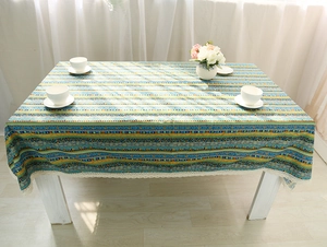 Detail of bohemian cotton linen tablecloth with colorful geometric patterns and lace trim