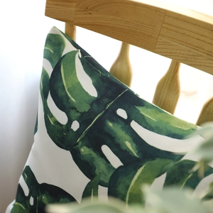Tropical monstera leaf decorative square pillow cover with invisible zipper on wooden chair