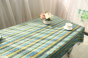 Macro detail of Bohemian rainbow striped linen tablecloth with white lace floral edging