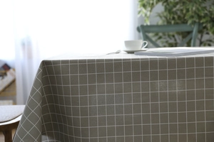 Detail of grey checked linen tablecloth showing texture with dining room decorations