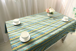 Detailed close-up of Bohemian striped cotton linen tablecloth with white lace trim