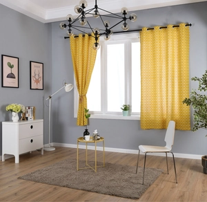 Detail of yellow cotton linen curtains with white geometric grid and silver metal grommets