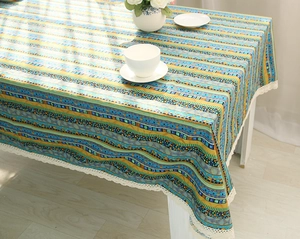 Close-up of Bohemian cotton linen tablecloth with wave stripes and white lace edge