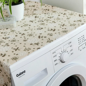 Detailed close-up of grey hyacinth floral cotton linen dust cover on a washing machine