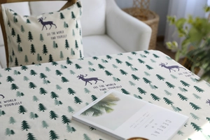 Close-up of linen fabric with green tree patterns and麋鹿 prints for home decor
