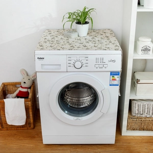 Close-up of floral linen dust cover on a front-load washing machine in a cozy home setting