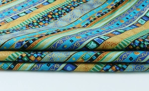 Detail showing folded ethnic bohemian tablecloth with colorful mosaic stripe patterns