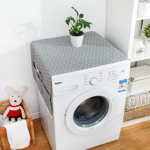 Gray geometric laundry machine dust cover with side pockets and white plush pom-poms