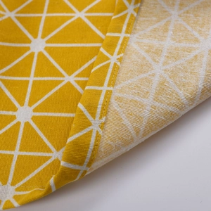 Detailed macro shot of yellow cotton linen curtain with white geometric triangle patterns