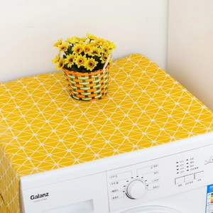 Detail of yellow fabric cover with white geometric patterns on a washing machine