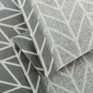 Close-up of Nordic cotton linen microwave cover with white geometric patterns and neat stitching