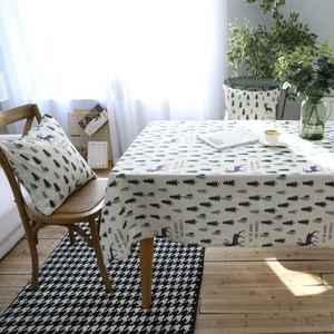 Modern linen tablecloth with green trees and reindeer prints for a cozy dining room
