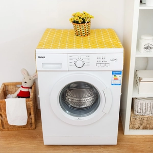 Detail of yellow geometric linen cover on a washing machine with modern decor