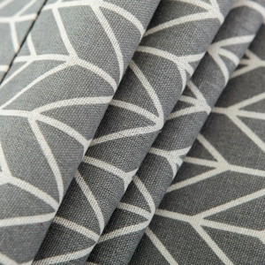 Close-up of dark grey cotton linen fabric with white geometric leaf vein pattern