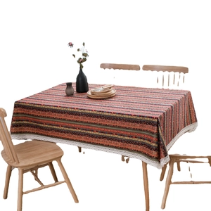 Bohemian colorful striped cotton linen tablecloth with elegant white lace trim on table