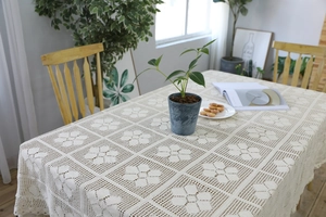 Detailed macro view of retro handmade crochet tablecloth with geometric lace patterns