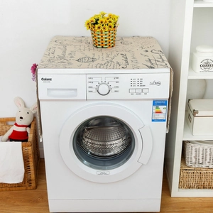 Close-up of linen dust cover with vintage script pattern on a top washing machine