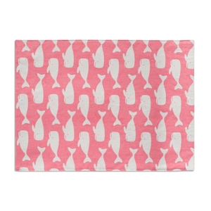 Detail of pink cotton placemat featuring a minimalist white cartoon whale print pattern
