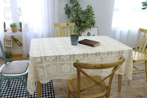 Close-up of handmade crochet lace tablecloth with intricate hollow floral patterns