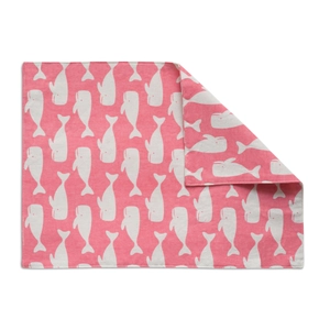 Detailed close-up of double-layer fabric placemat with pink whale print and neat stitching