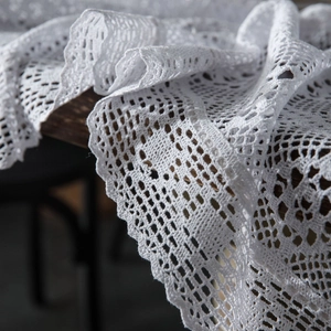 White crochet lace tablecloth with vintage hollow mesh and elegant scalloped edges