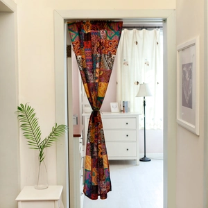 Close-up of bohemian linen door curtain featuring colorful geometric and floral patchwork