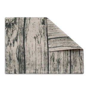 Macro shot of double-layered bohemian placemat with grey-black rustic wood grain pattern