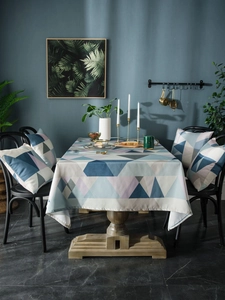 Waterproof Nordic geometric tablecloth with matching square pillows in a cozy dining setting